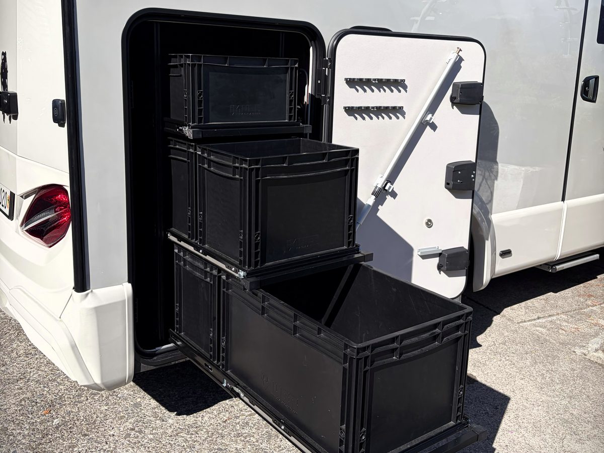 Ausgefahrener Heckauszug mit drei Transportboxen aus der Heckgarage eines Reisemobils